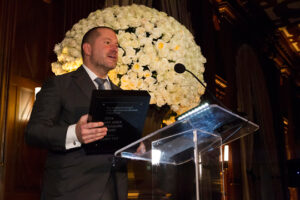 A man in a suit at a podium