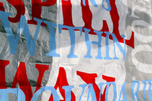 A banner with blue, red and white overlapping words