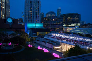 A night shot of Yerba Buena Gardens showing the lit-up Modern Ball tent