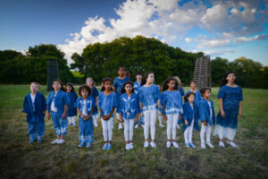 A group of children standing in a field
