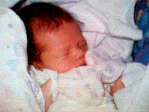 photograph of a baby in heart print clothing and blanket